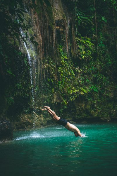 Dad making a splash diving off the waterfall